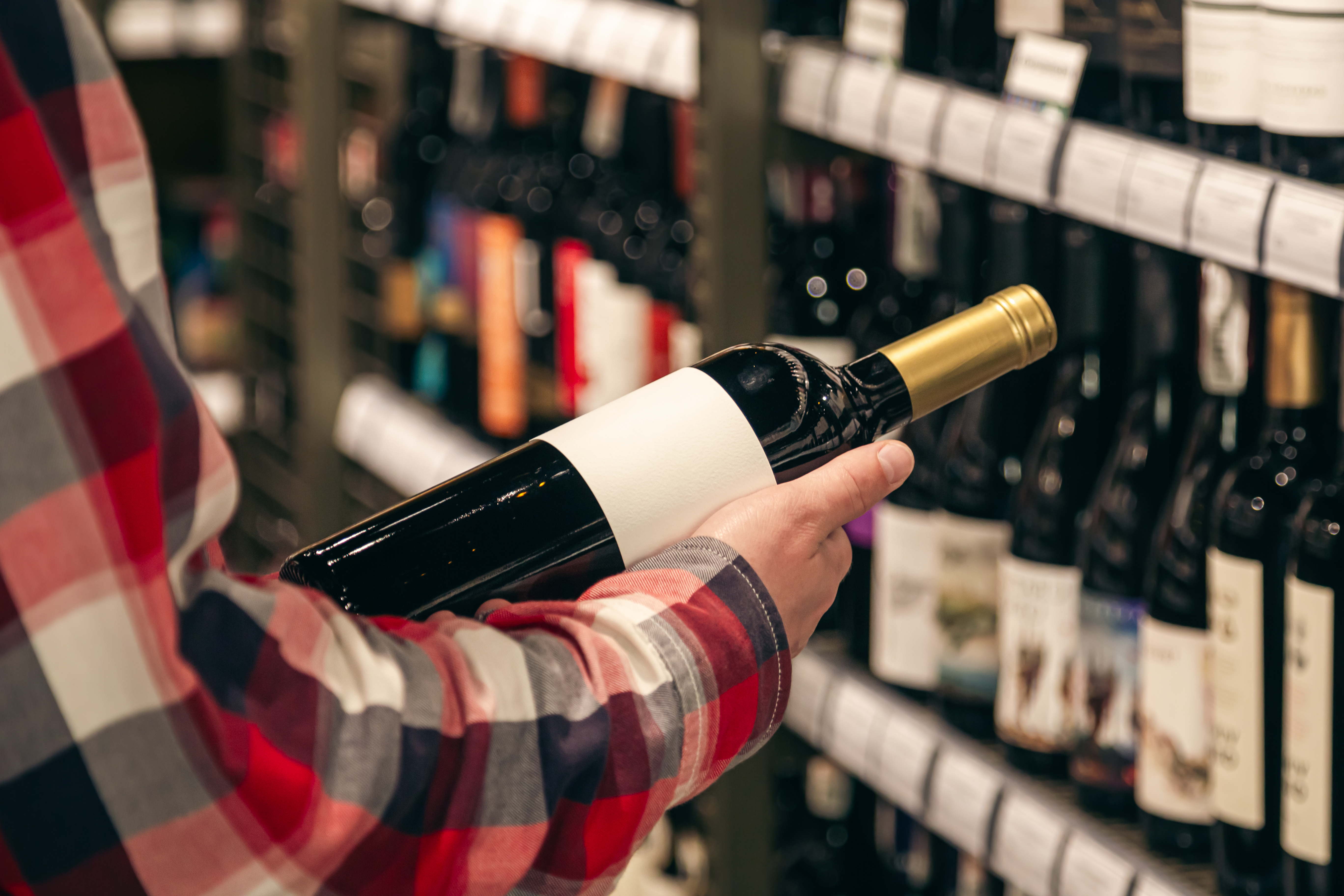 Person inspecting wine in wine storage